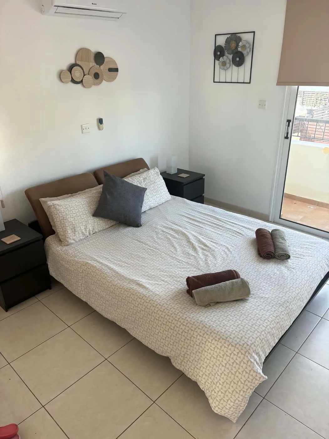 Palm Villa double bedroom with balcony door and air conditioning unit