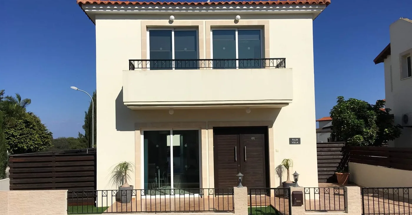 Palm Villa front exterior — two-storey cream villa with balcony, Pernera Cyprus