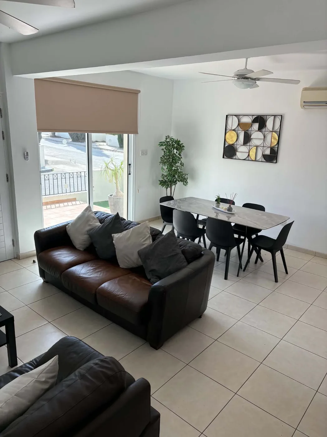 Palm Villa open-plan lounge and dining room with terrace and pool view