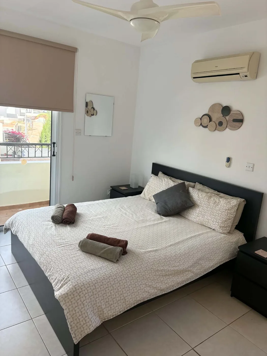 Palm Villa master bedroom with balcony access and air conditioning