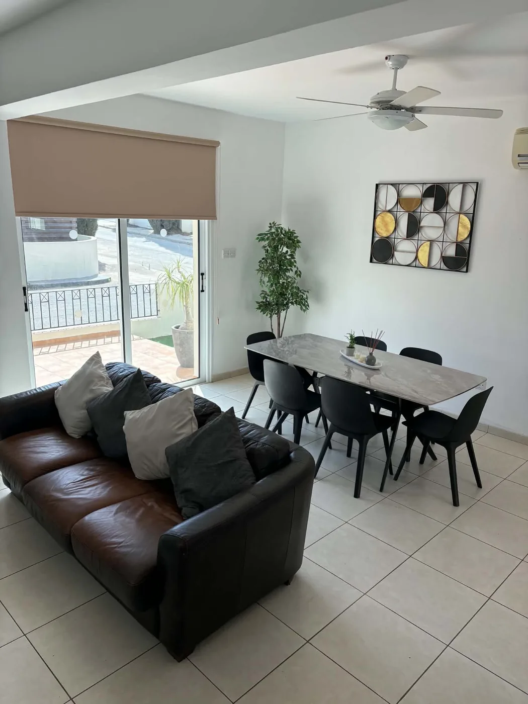 Palm Villa open-plan lounge and dining area with large dining table and balcony