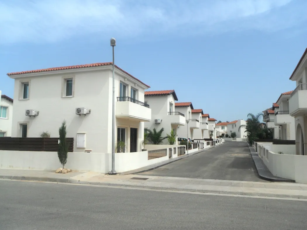 Quiet residential street of white villas leading up to Palm Villa, Pernera Cyprus