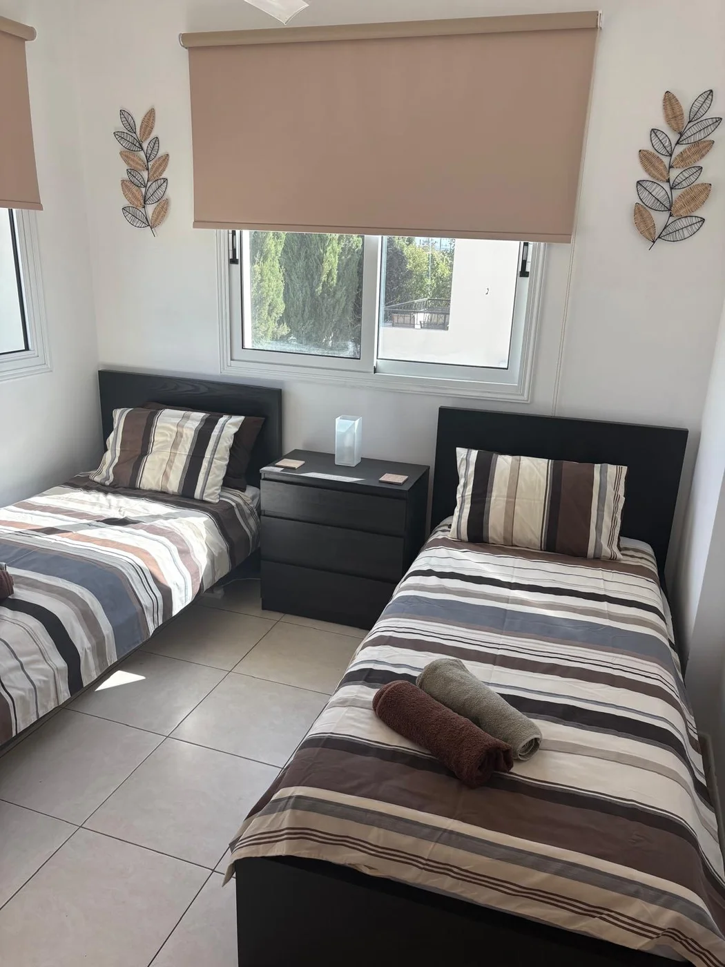 Palm Villa twin bedroom with two single beds — travel cot available on request